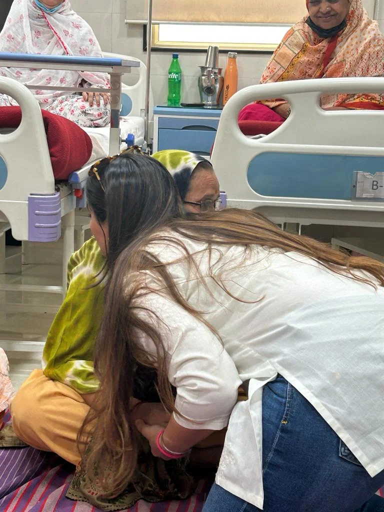A group of women gathered at a community cancer screening and awareness camp